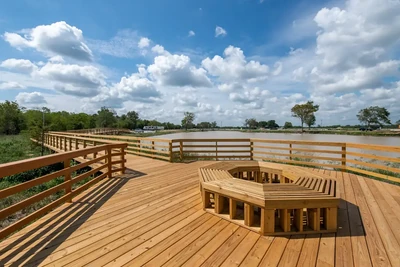 Wood deck and railing overlooking a pond